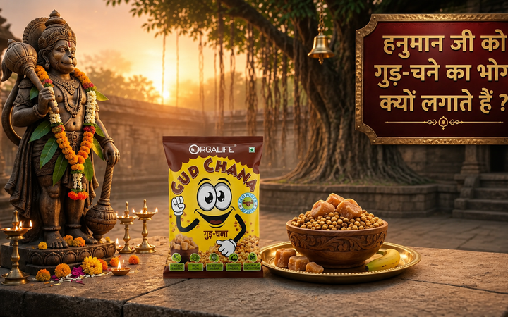 A devotional scene featuring Lord Hanuman, an Orgalife Gud Chana packet, and a bowl of jaggery with roasted gram prasad, symbolizing the traditional Tuesday offering for blessings, strength, and positive energy.